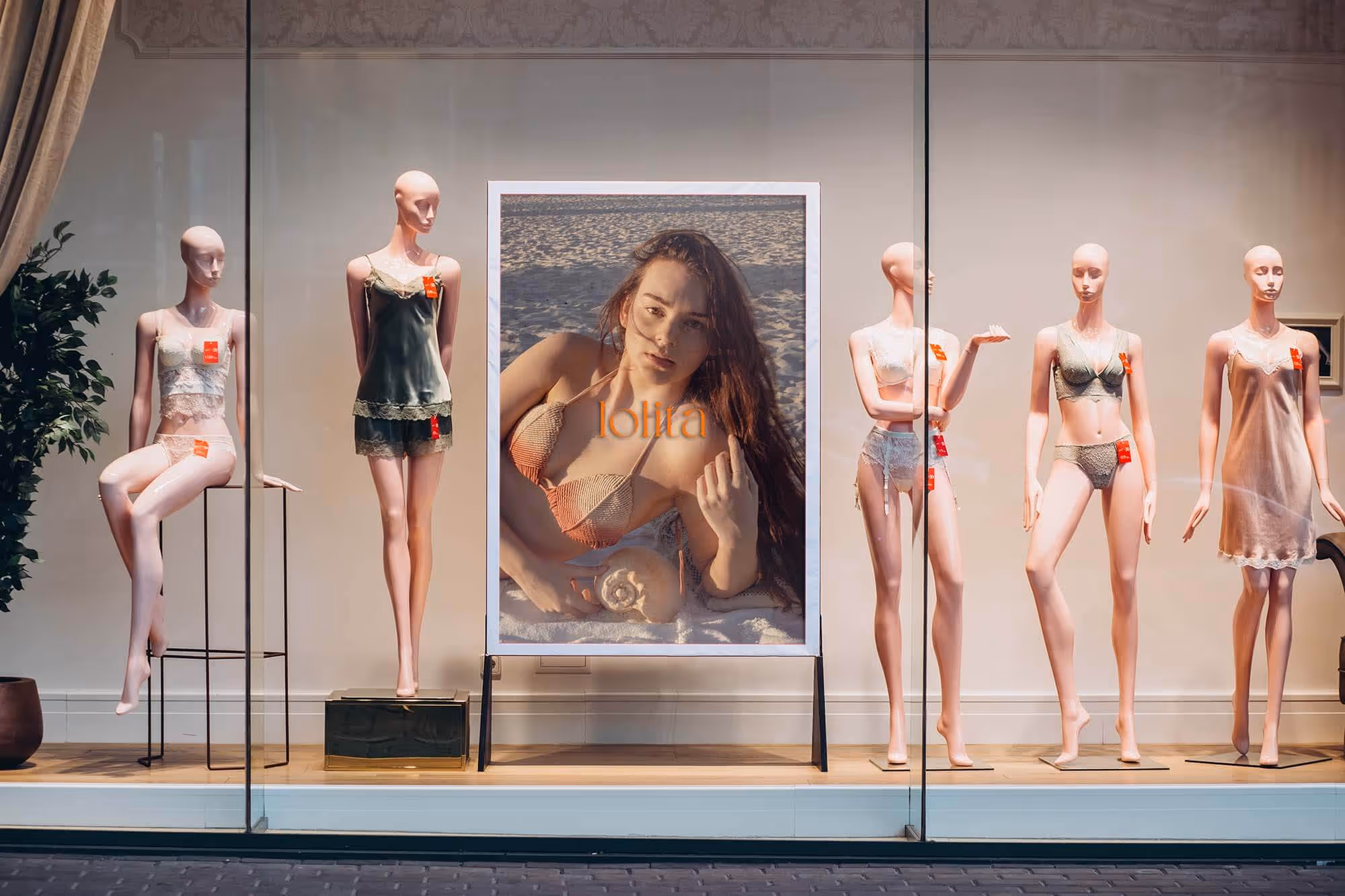outside window with mannequins and a big photo vertical banner