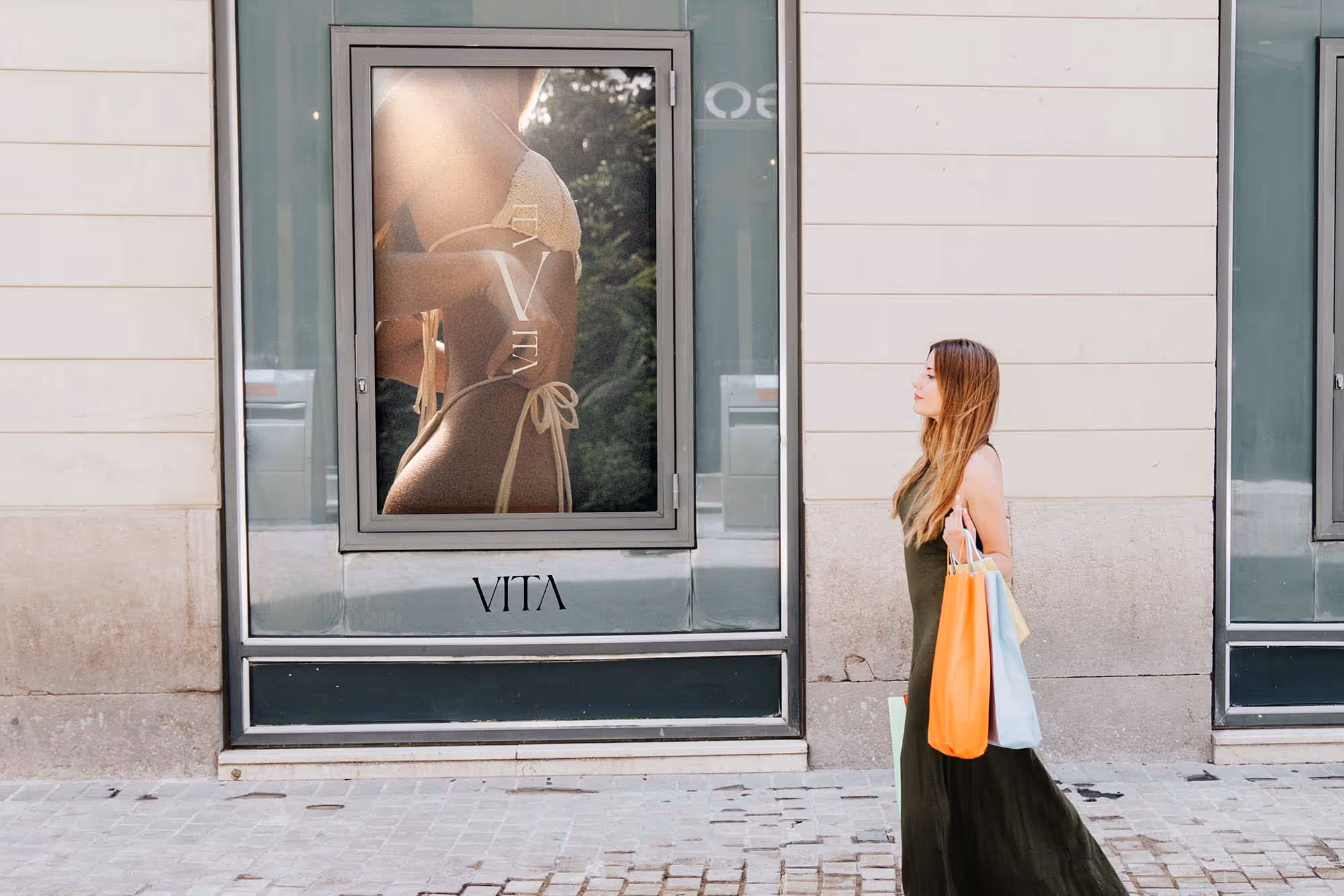 Picture of a banner with a photo on the outside window frame of a bikini shop